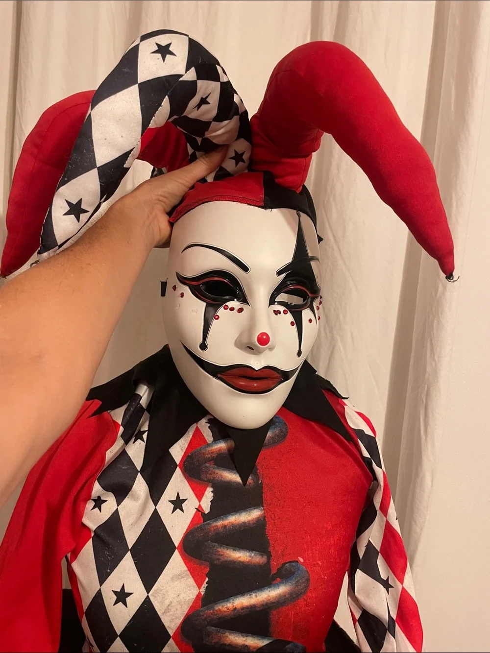 Dirty, scary Jack-in-box Halloween costume or cosplay, including jeweled mask.